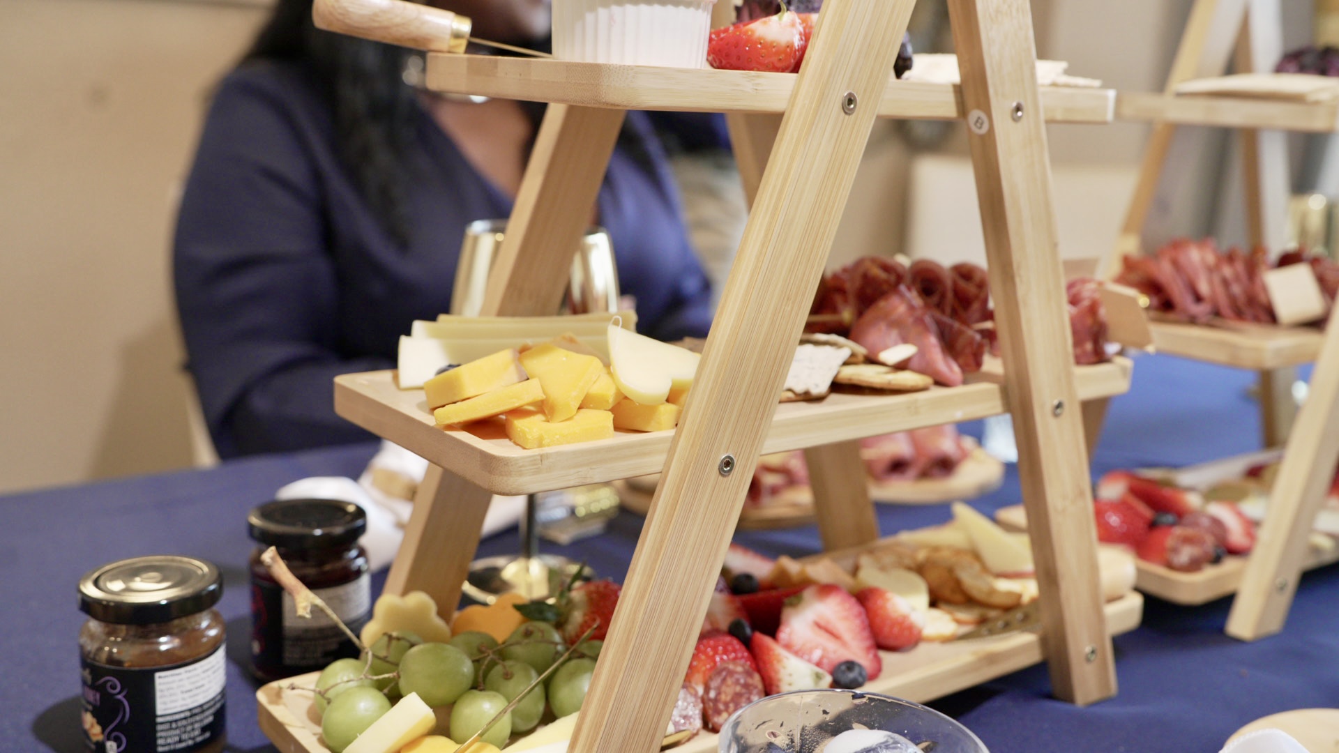 Tiered ladder display of charcuterie and fruit
