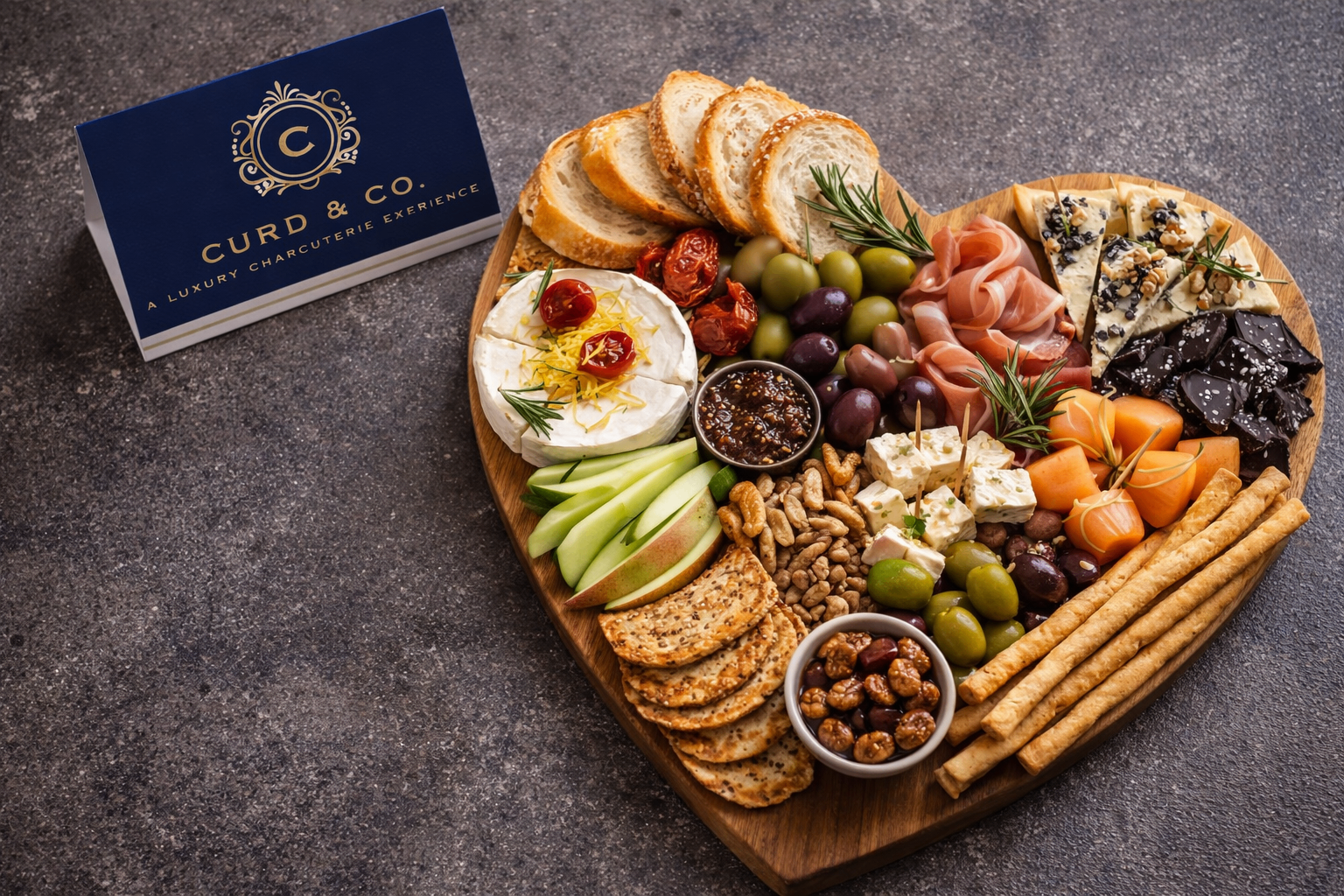 Heart-shaped Mediterranean charcuterie board with branded card
