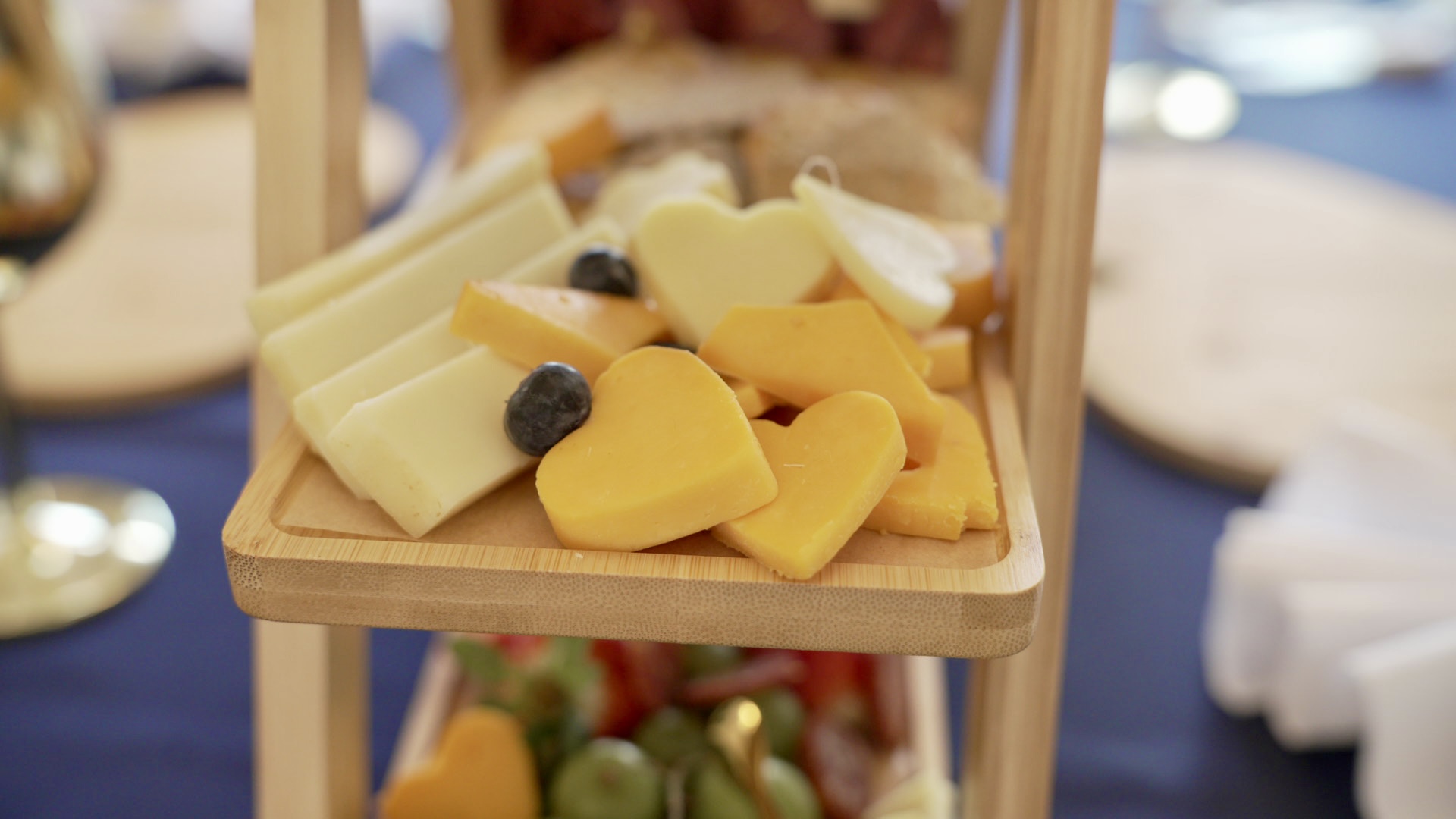 Heart-shaped cheese detail on bamboo board